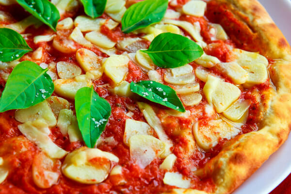 pizza with tomato sauce basil and mushrooms