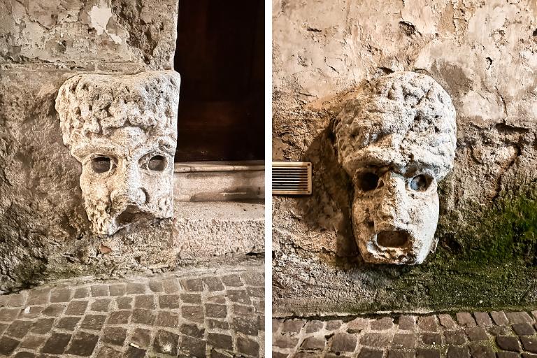 Faces carved into the facade of buildings in Benevento