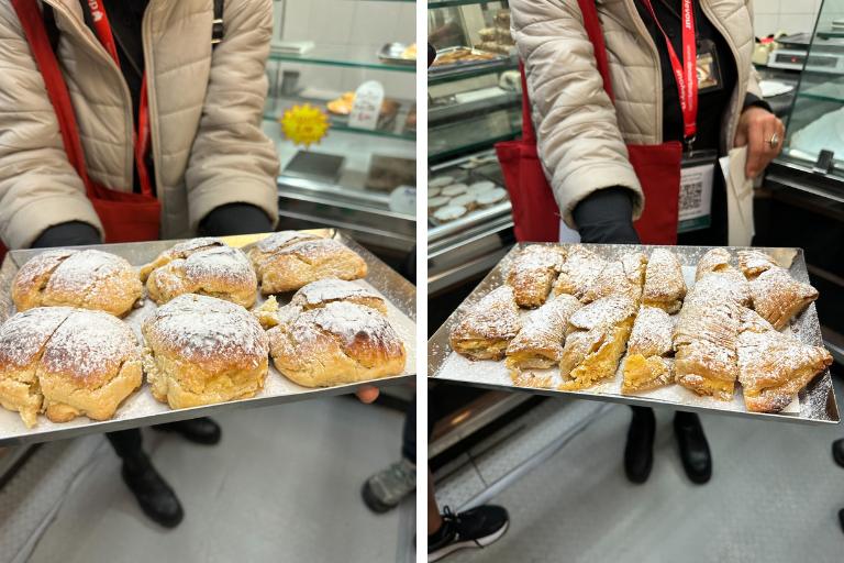 a person holding a tray of pastries